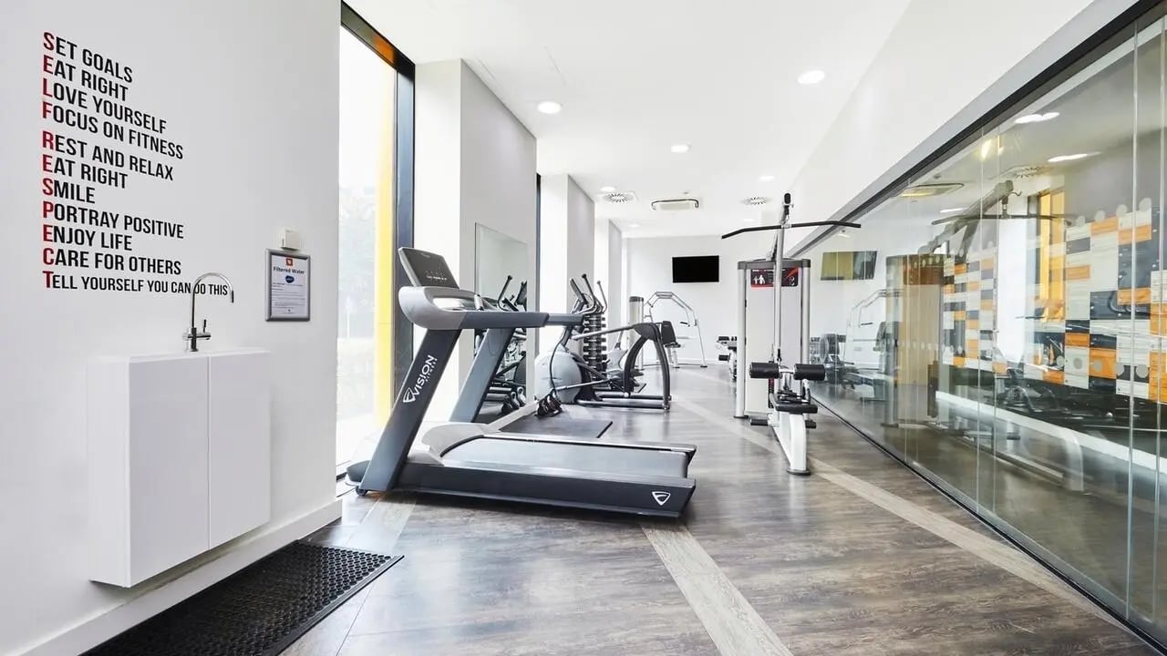 Gym with treadmills and weight machines fitness room at Collegiate Tower in Bristol Student Accommodation