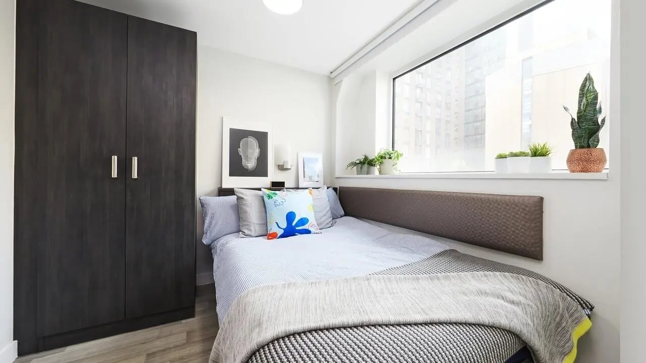 Dark wardrobe bed with plants Bedroom at Collegiate Tower in Bristol Student Accommodation