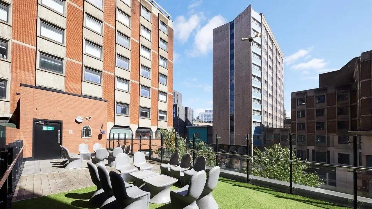 Outdoor seating area with modern chairs and tables exterior at Collegiate Tower in Bristol Student Accommodation