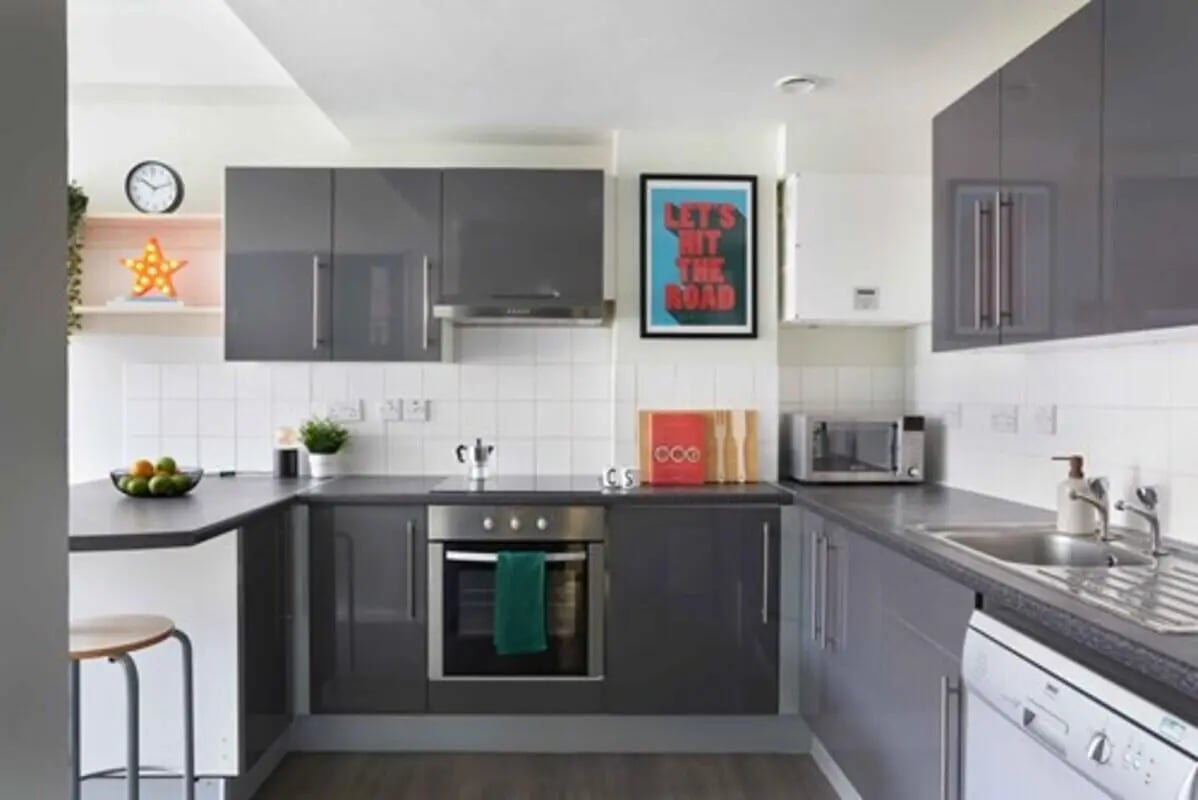 Modern grey cabinets oven microwave sink dishwasher kitchen at Culver House in Bristol Student Accommodation