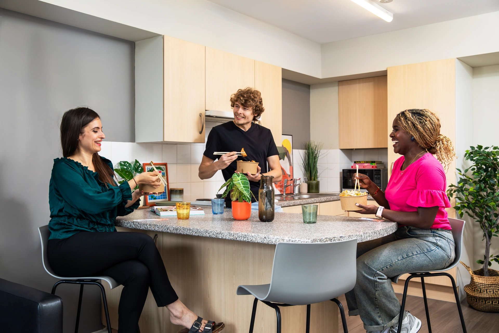 People eating in a modern student kitchen at Pacific Court in London Student Accommodation