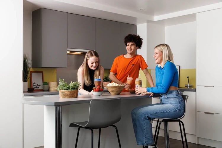 Students in modern kitchen with snacks and drinks kitchen at Newgate Court in Newcastle Upon Tyne Student Accommodation