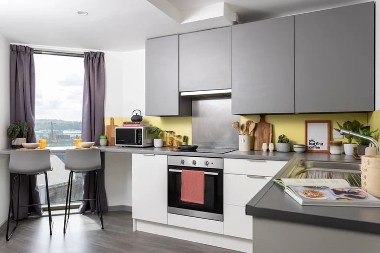 Kitchenette with microwave oven and bar stools kitchen at Newgate Court in Newcastle Upon Tyne Student Accommodation