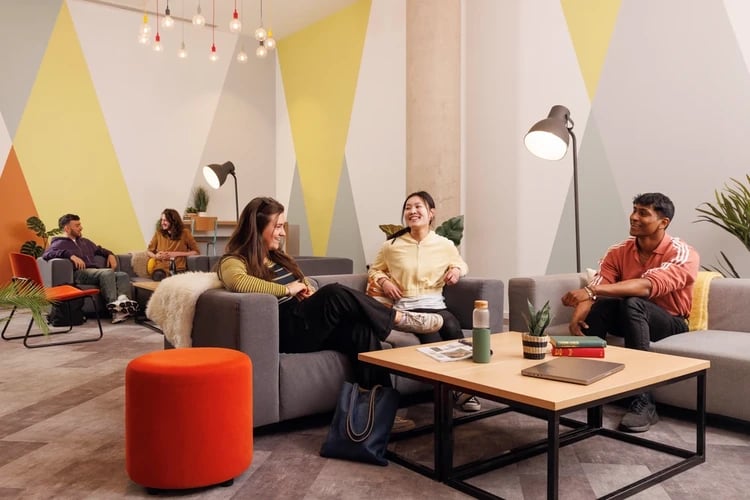 Students on sofas with coffee table living room at Newgate Court in Newcastle Upon Tyne Student Accommodation