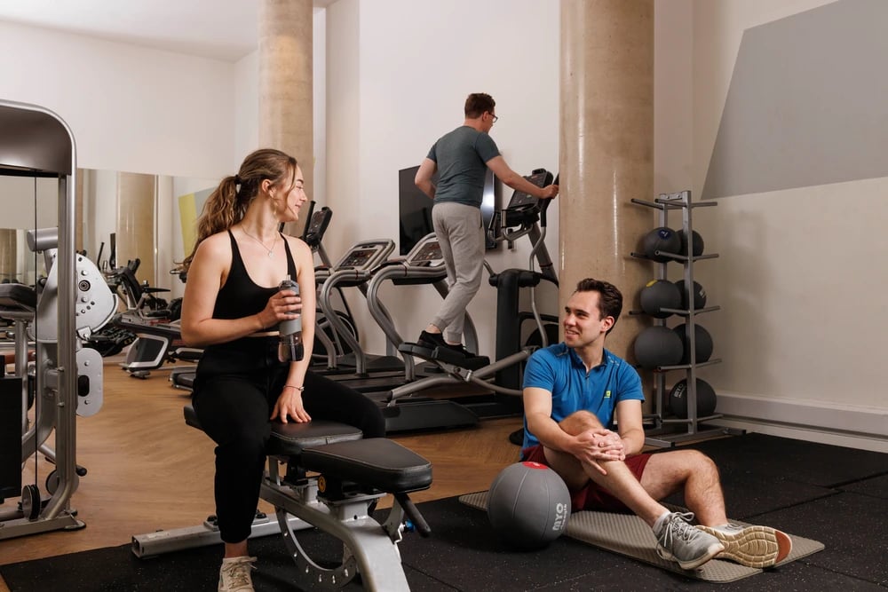 People exercising in gym with equipment playing area at Newgate Court in Newcastle Upon Tyne Student Accommodation