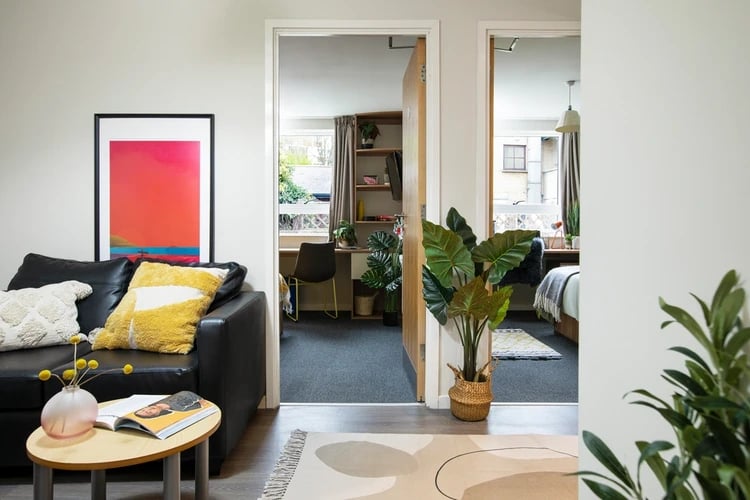 Black sofa artwork throws and coffee table living room at Elizabeth Croll House in London Student Accommodation