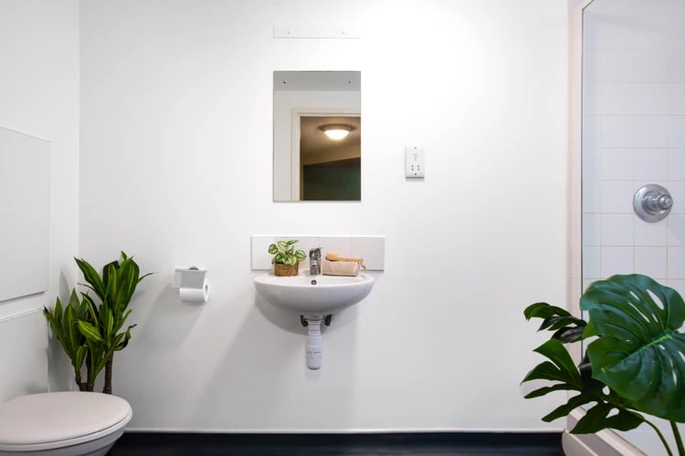 Toilet sink plants and shower stall bathroom at Elizabeth Croll House in London Student Accommodation