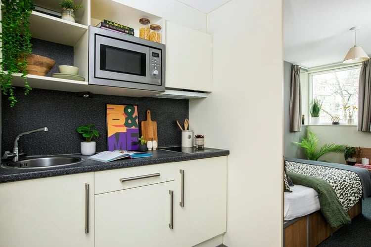 Kitchen area with microwave sink and bedding at Elizabeth Croll House in London Student Accommodation