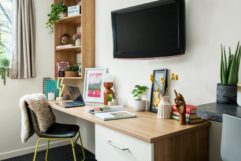 Desk chair laptop books and plants study area at Elizabeth Croll House in London Student Accommodation