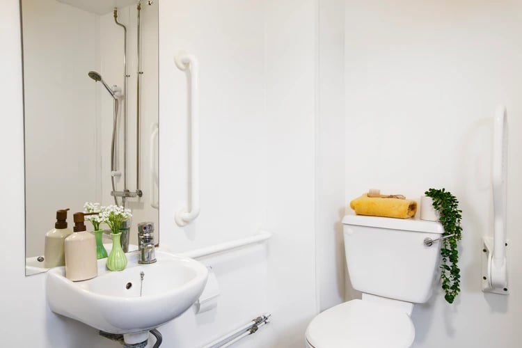 Sink shower toilet grab bars towel bathroom at East Central House in London Student Accommodation