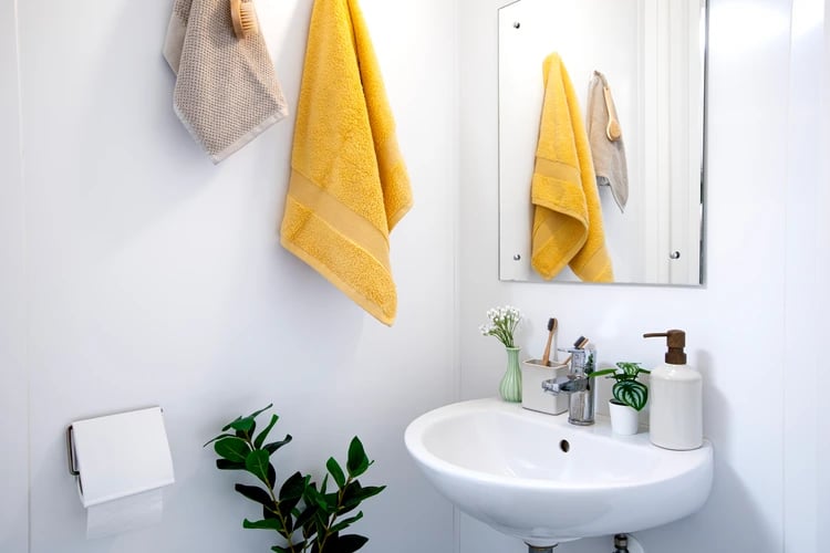 Sink with soap dispenser and towels bathroom at East Central House in London Student Accommodation