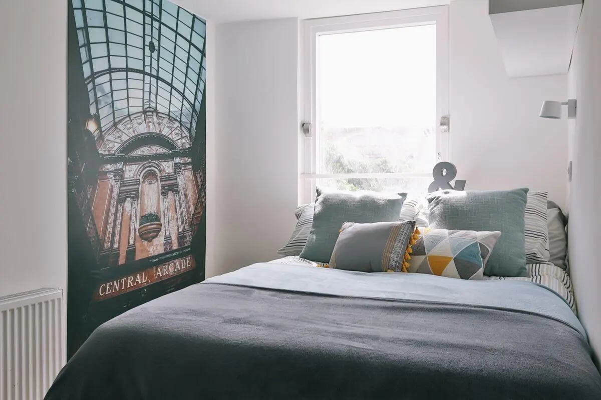 Bed with grey duvet pillows and artwork Bedroom at Claremont Place in Newcastle Upon Tyne Student Accommodation