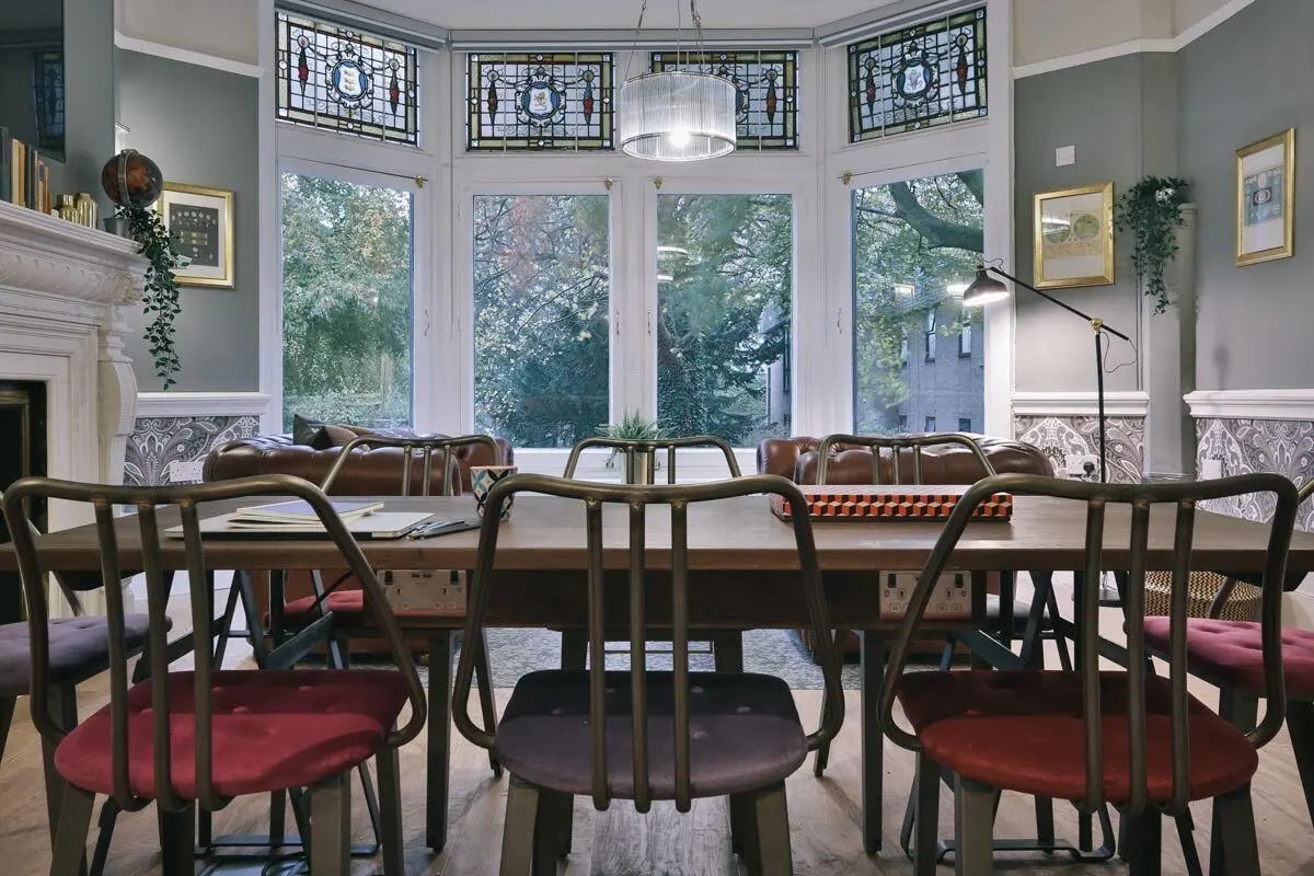 Dining table with chairs and leather sofas living room at Claremont Place in Newcastle Upon Tyne Student Accommodation