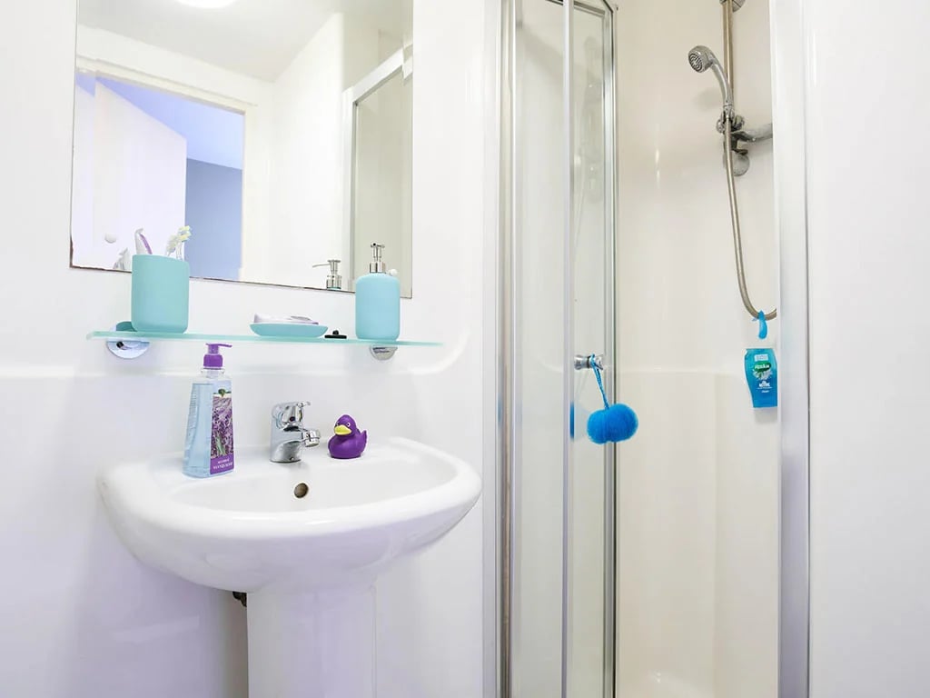 Sink with soap dispenser and shower cubicle bathroom at Europa in Liverpool Student Accommodation