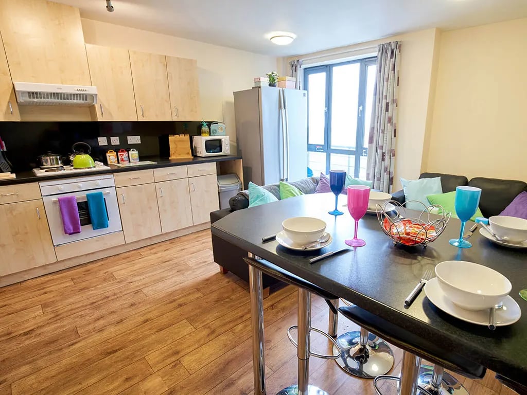 Kitchen dining area with sofa living room at Europa in Liverpool Student Accommodation