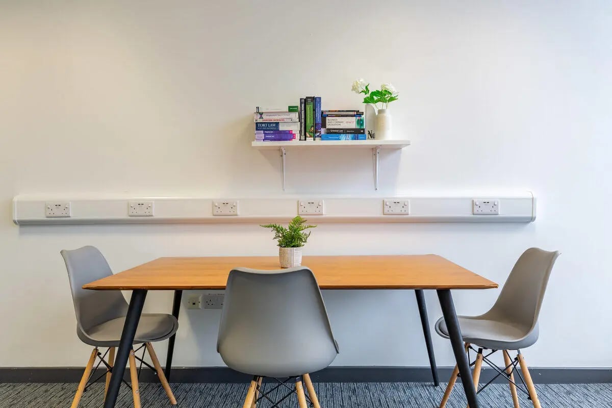 Table chairs plant shelf books and flowers study area at Glassworks - Liverpool in Liverpool Student Accommodation