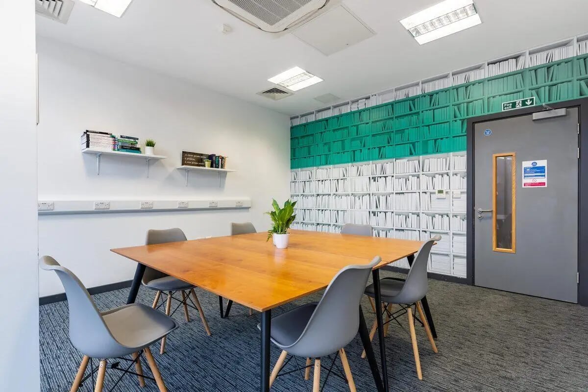 Table with chairs on patterned carpet study area at Glassworks - Liverpool in Liverpool Student Accommodation