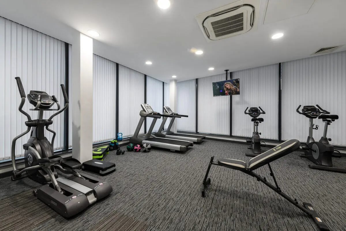 Gym with treadmills bikes bench weights tv. at Glassworks - Liverpool in Liverpool Student Accommodation