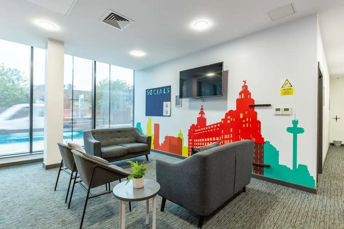 Sofas chairs television mural and plant lounge at Glassworks - Liverpool in Liverpool Student Accommodation