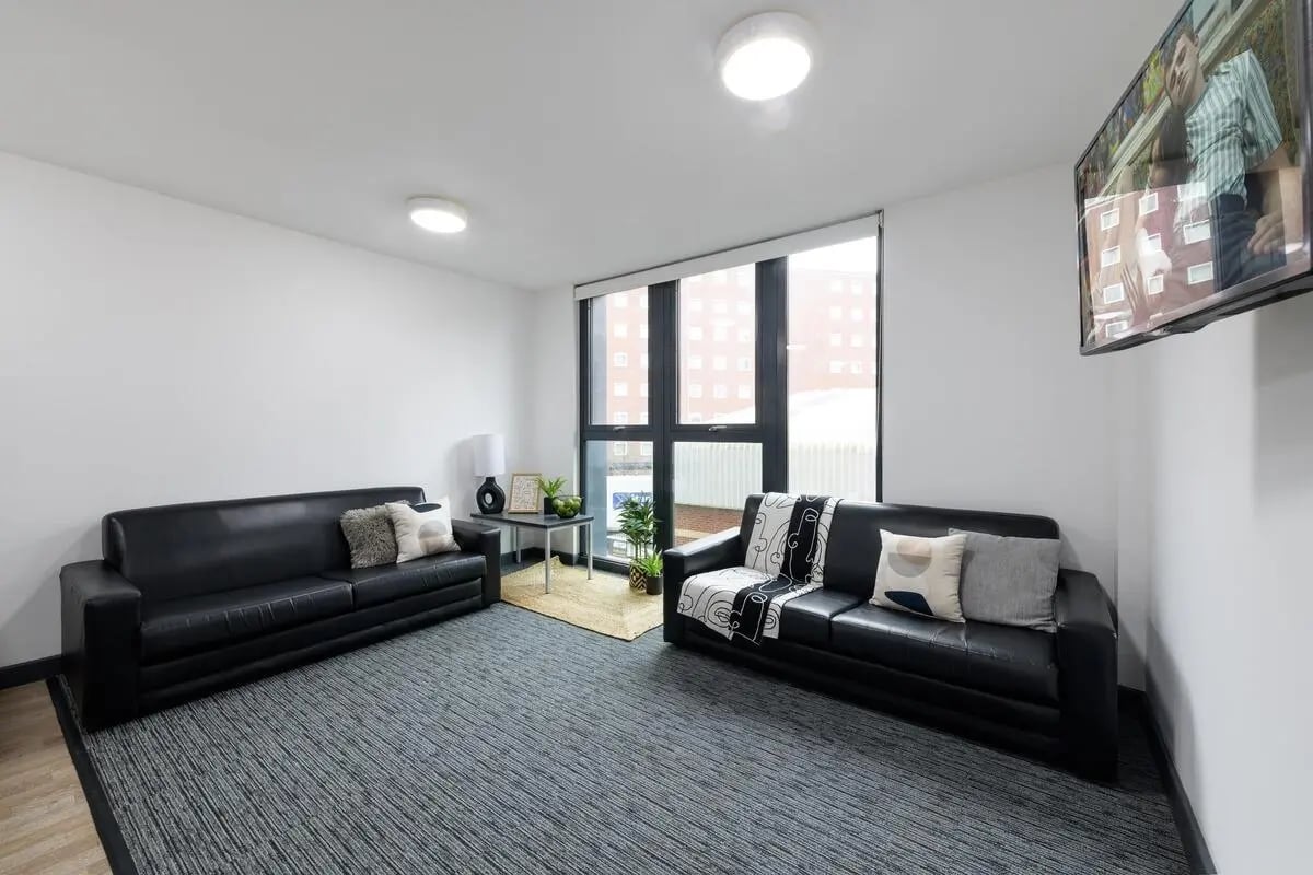 Two black sofas with cushions living area at Glassworks - Liverpool in Liverpool Student Accommodation