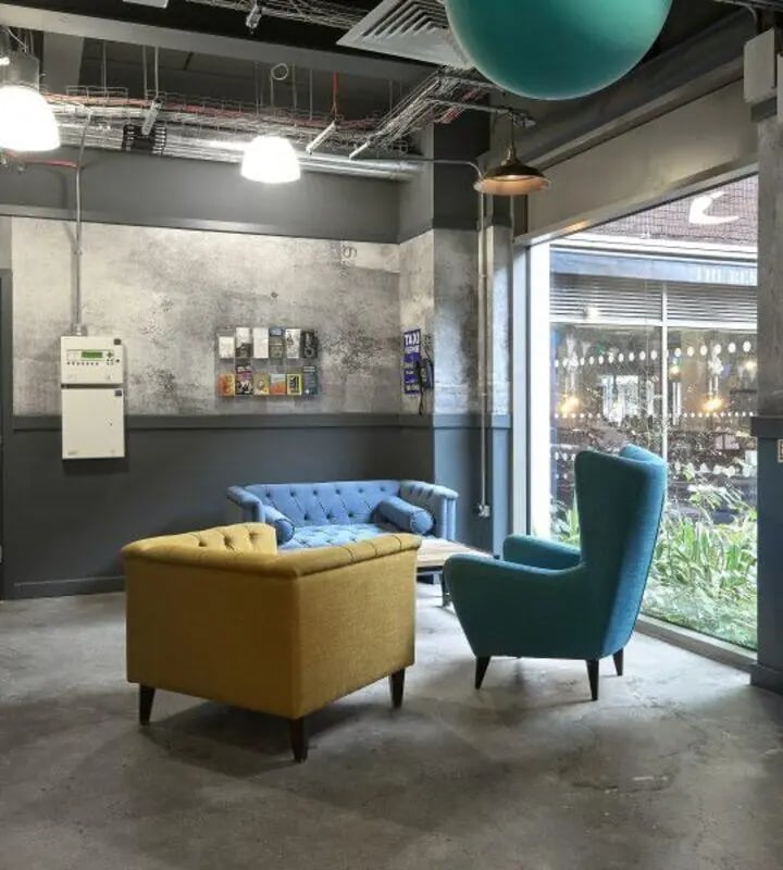 Blue and yellow couches and chair living area at Hope Street in Liverpool Student Accommodation