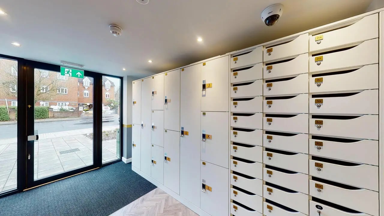 White mailboxes and lockers with numbered slots exterior at Astra House in London Student Accommodation