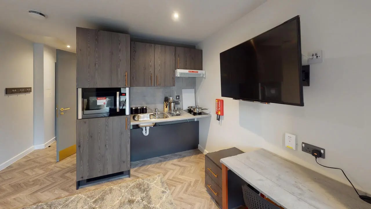Modern kitchenette with microwave sink and desk kitchen at Astra House in London Student Accommodation