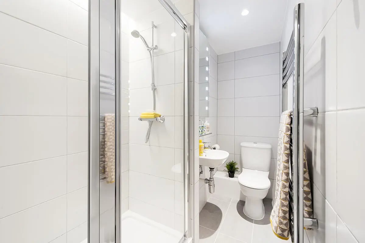 Shower sink toilet and towel rack bathroom at Yugo Therese House in London Student Accommodation