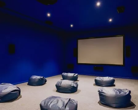 Blue room with screen and beanbags cinema area at Scape Mile End in London Student Accommodation