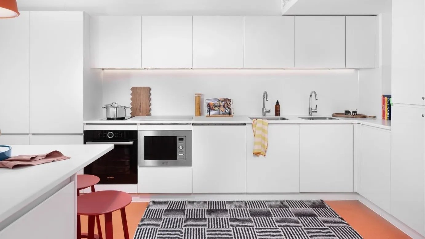 Modern white kitchen with integrated appliances kitchen at Scape Mile End in London Student Accommodation