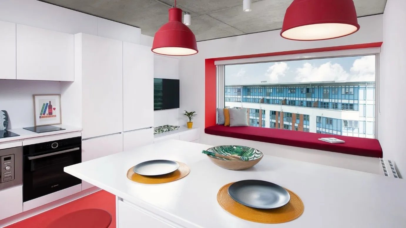 White kitchen island with plates and bowl kitchen at Scape Mile End in London Student Accommodation