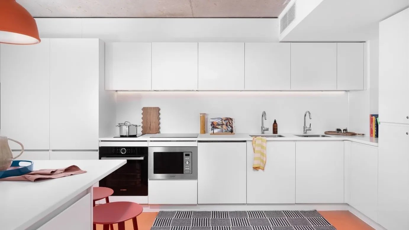 White cabinets oven microwave sink and counter kitchen at Scape Mile End in London Student Accommodation