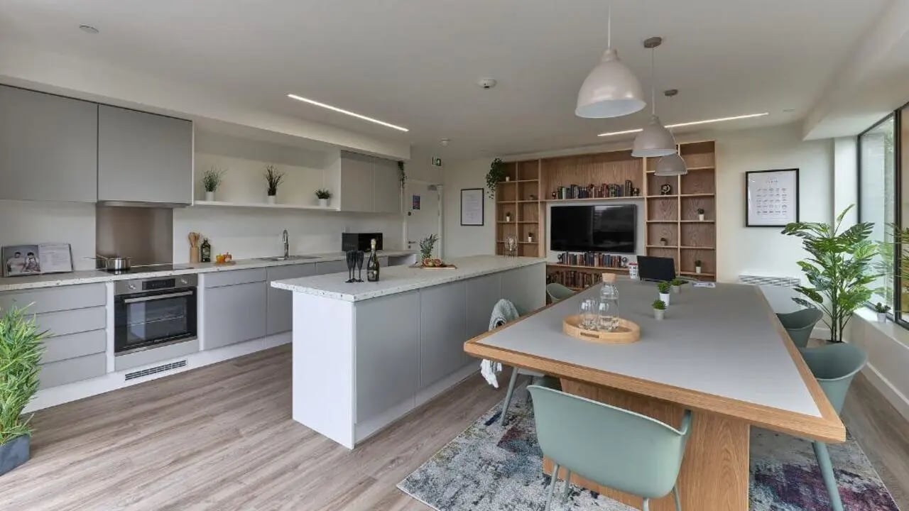 Modern kitchen island oven and communal dining table kitchen at Host View Studios in London Student Accommodation