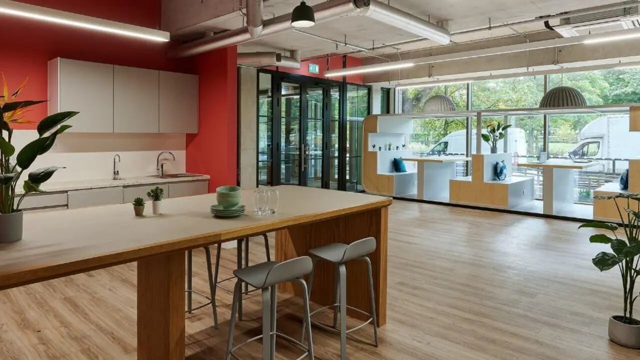 Kitchen island with stools red wall modern kitchen common area at Host View Studios in London Student Accommodation