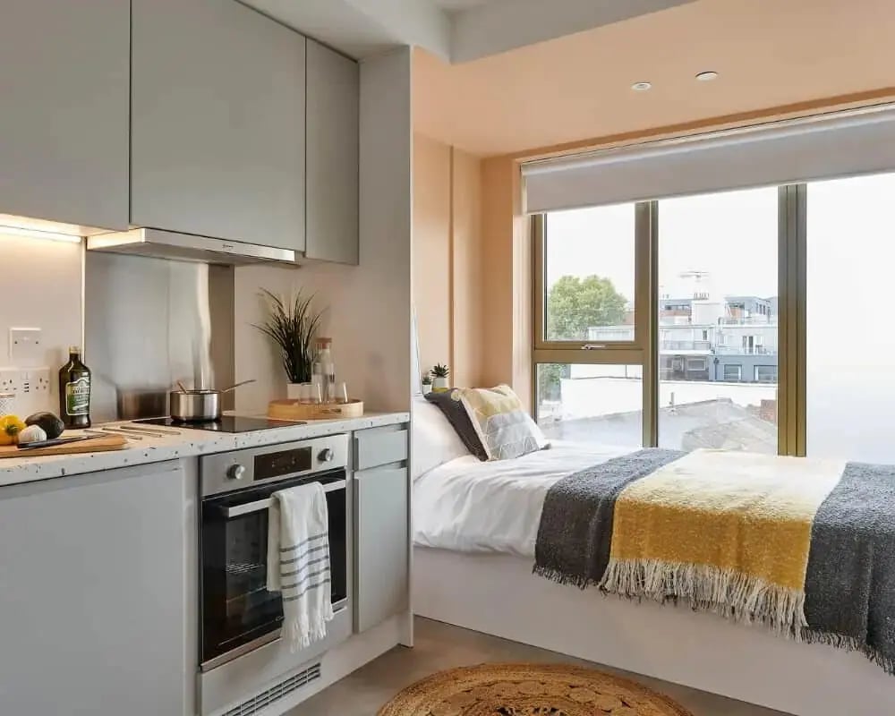 Kitchen and bed with blankets living room at Host View Studios in London Student Accommodation