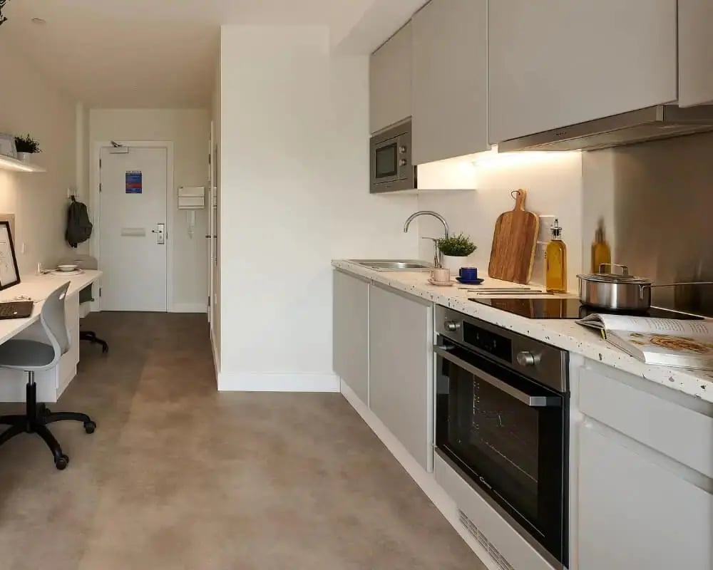 Desk and kitchen area modern studio living room at Host View Studios in London Student Accommodation