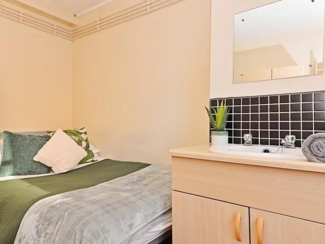 Bed sink mirror plant and towel bathroom at St Andrews Gardens - Liverpool in Liverpool Student Accommodation