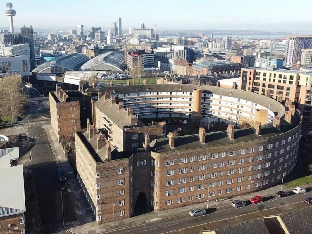 Curved brick apartment building with many windows exterior at St Andrews Gardens - Liverpool in Liverpool Student Accommodation