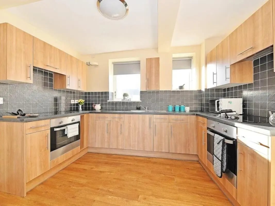 Light wood cabinets and black tiled backsplash kitchen at St Andrews Gardens - Liverpool in Liverpool Student Accommodation