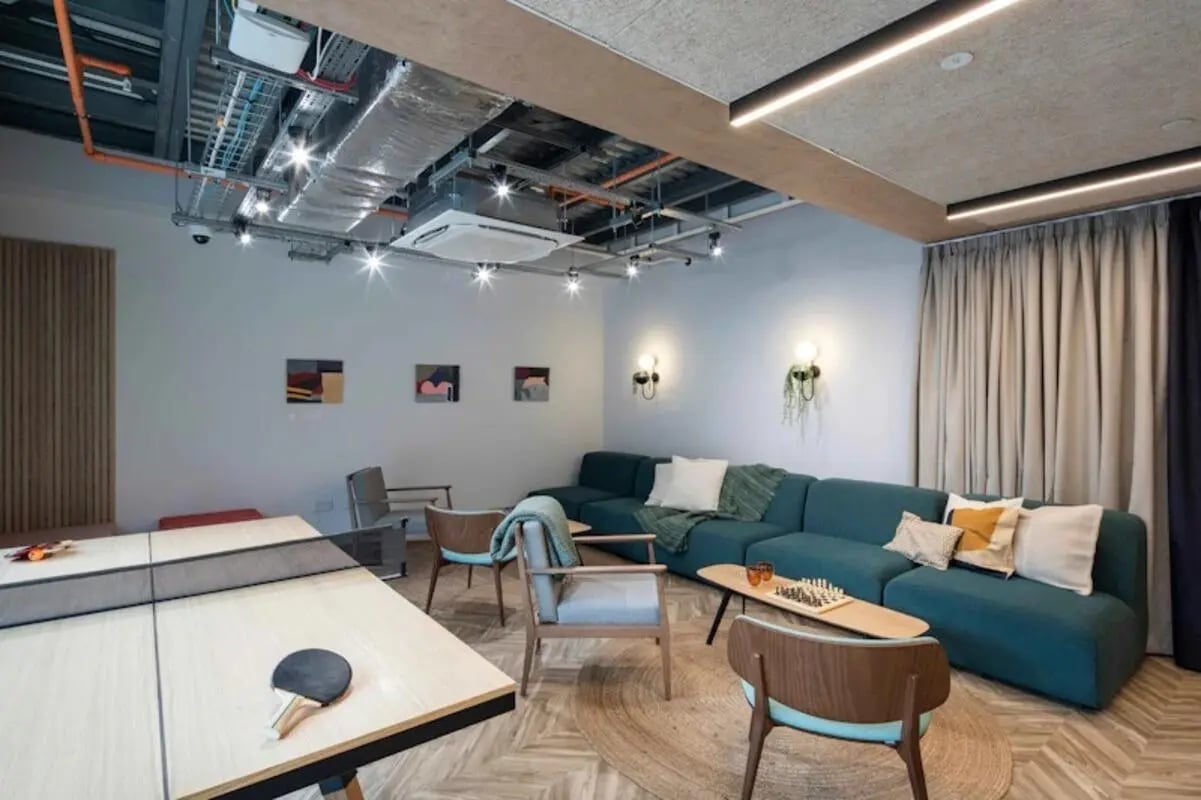 Ping pong table couch chess set living area at The Keel Houses in Edinburgh Student Accommodation