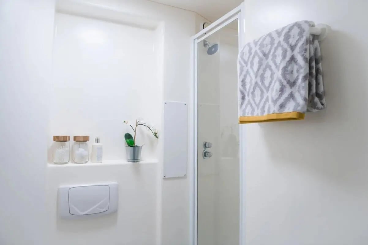 Shower glass towel toiletries and plant bathroom at McDonald Road in Edinburgh Student Accommodation