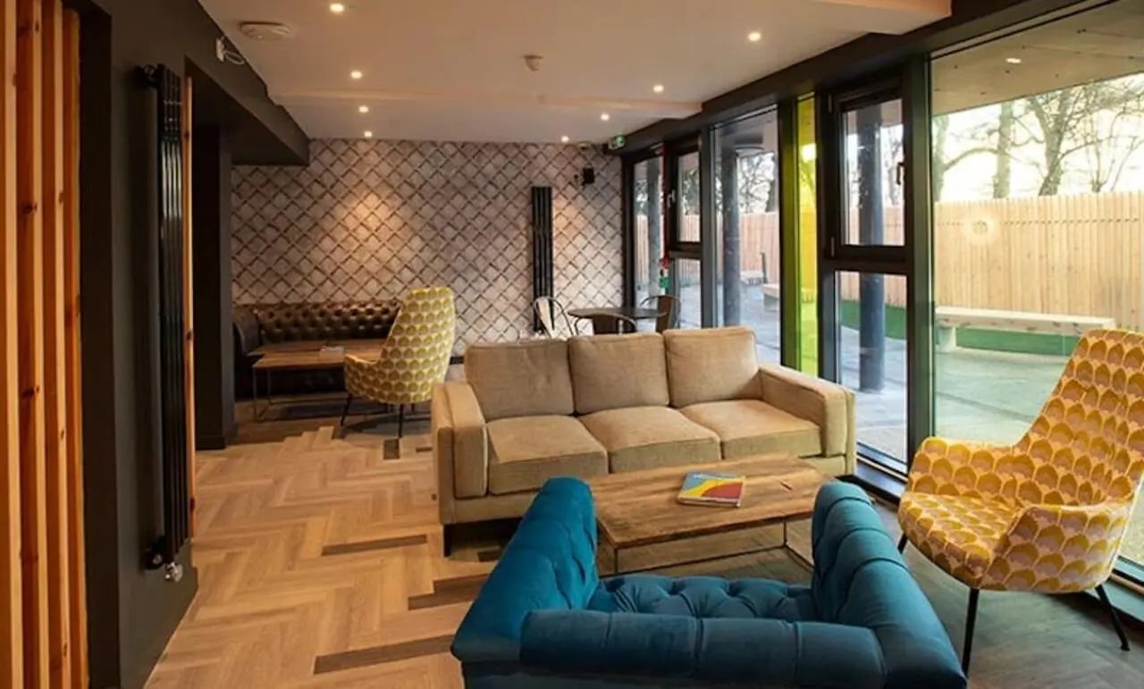 Sofas table chairs patterned chairs living room at McDonald Road in Edinburgh Student Accommodation