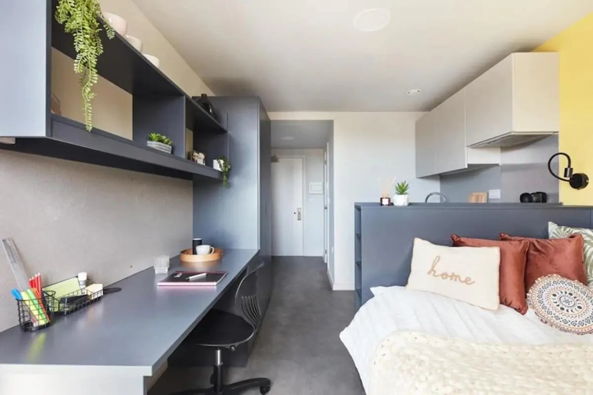 Desk bed shelves and kitchen area studio at Ravilious House in Brighton Student Accommodation