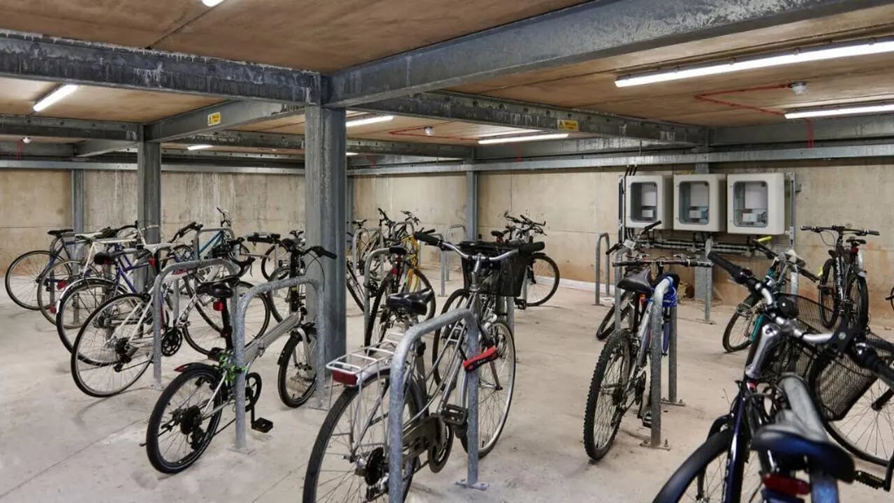 Bicycles parked in racks inside a covered area bicycle parking at Exeter Trust House in Exeter Student Accommodation