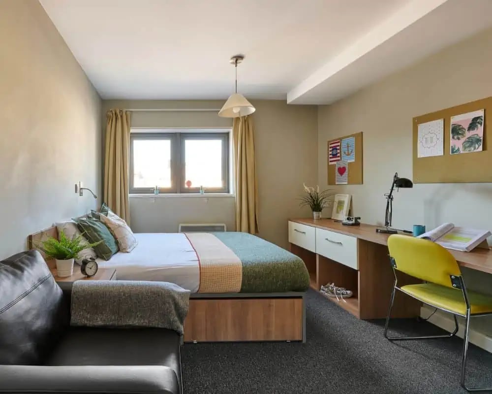 Bed desk chair and couch bedroom at Exeter Trust House in Exeter Student Accommodation