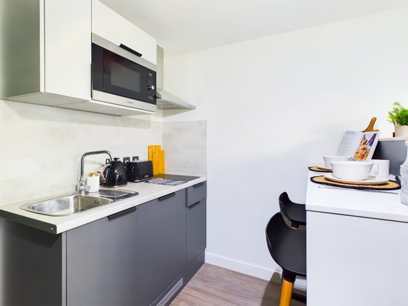 Modern kitchenette with microwave kettle toaster and sink kitchen at The Edge in Belfast Student Accommodation