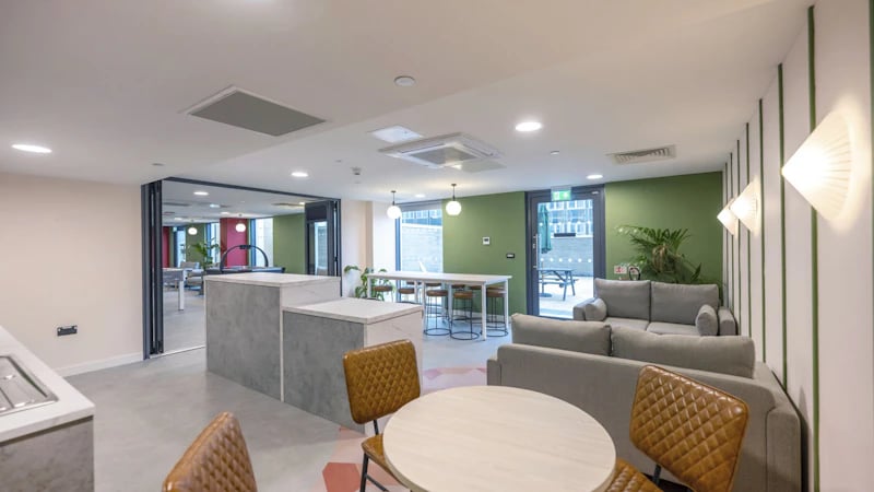 Sofa tables chairs kitchen island communal area at The Edge in Belfast Student Accommodation