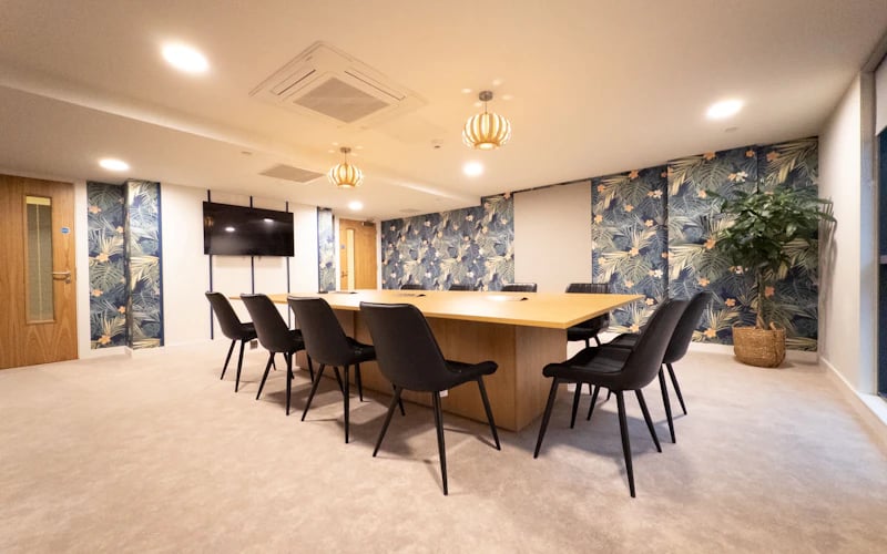 Large wooden table and black chairs communal space at The Edge in Belfast Student Accommodation