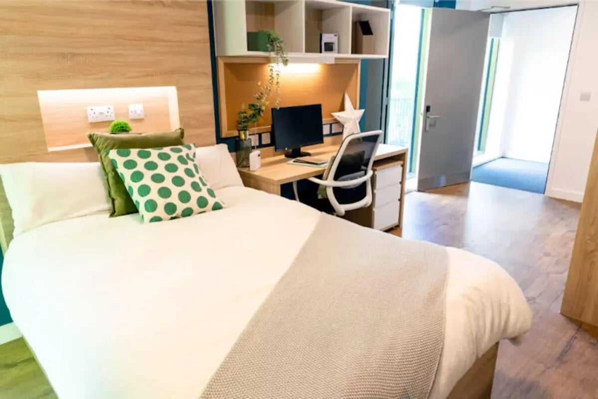Bed desk chair pillows and shelves bedroom at Bankside Student Living - Guildford in Guildford Student Accommodation