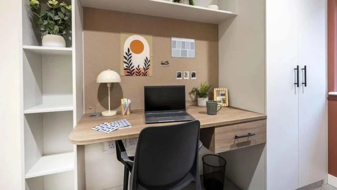 Desk with laptop lamp plant and chair study area at Raffles Hall in York Student Accommodation